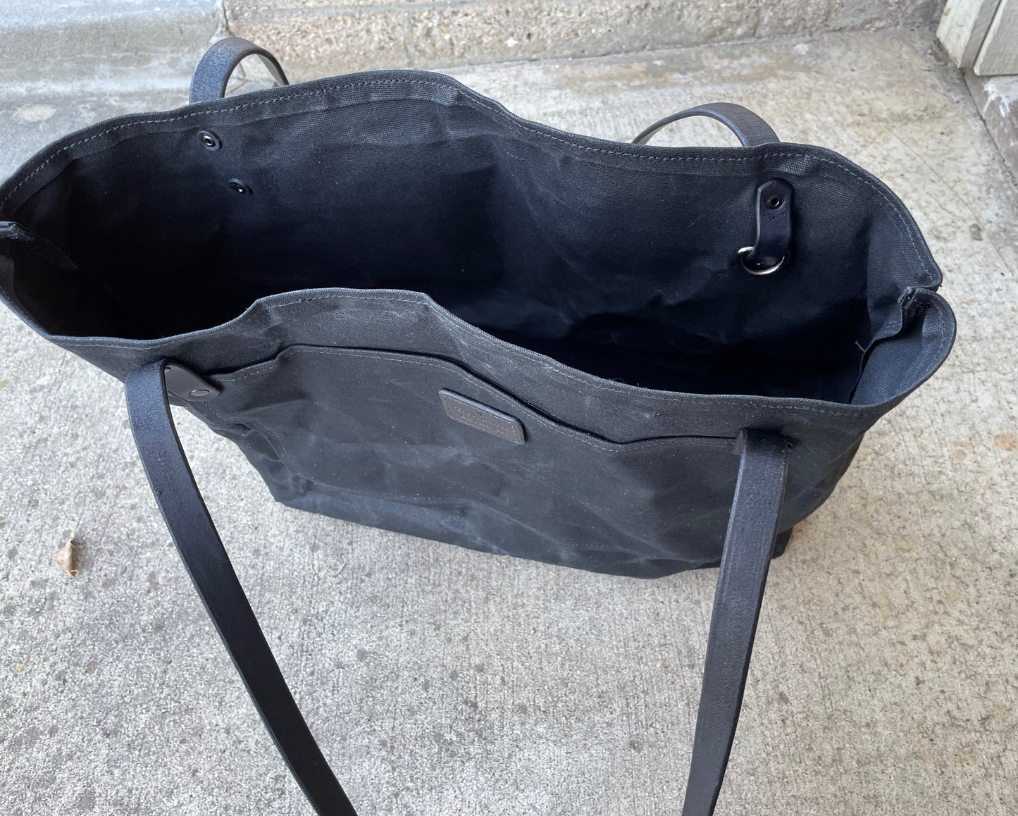 Top view of the waxed canvas market tote in the blackout colorway. 