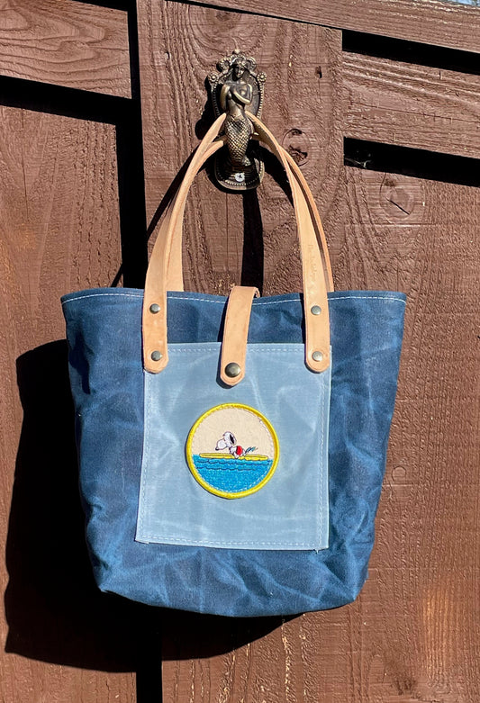 The Jackalope Mini Market Tote in blue waxed canvas with a Snoopy Surf Patch